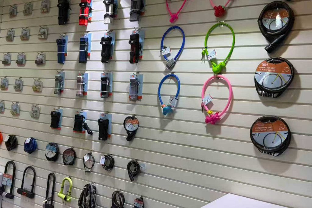 Wholesale bicycle lock factory showroom display, heavy-duty 4-digit combination bike cable lock and U-lock slotwall rack for retail supplier.